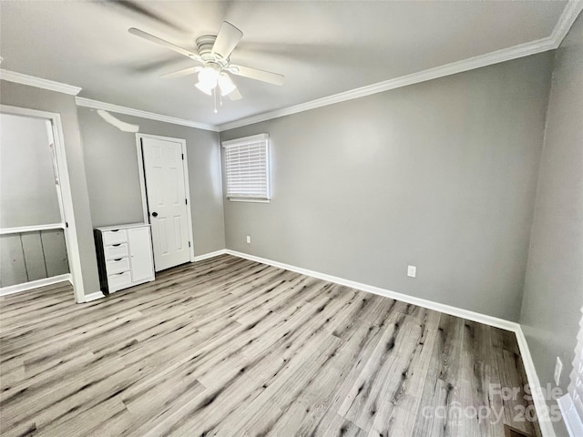 unfurnished bedroom with crown molding, baseboards, ceiling fan, and wood finished floors