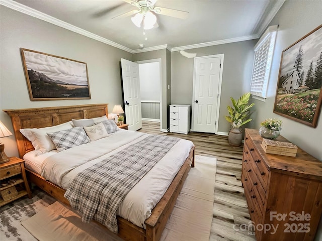 bedroom featuring a ceiling fan, baseboards, ornamental molding, and wood finished floors