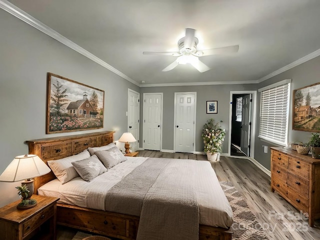 bedroom with a ceiling fan, crown molding, baseboards, and wood finished floors