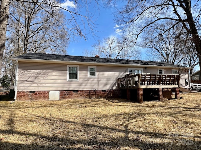 rear view of property featuring crawl space and a deck