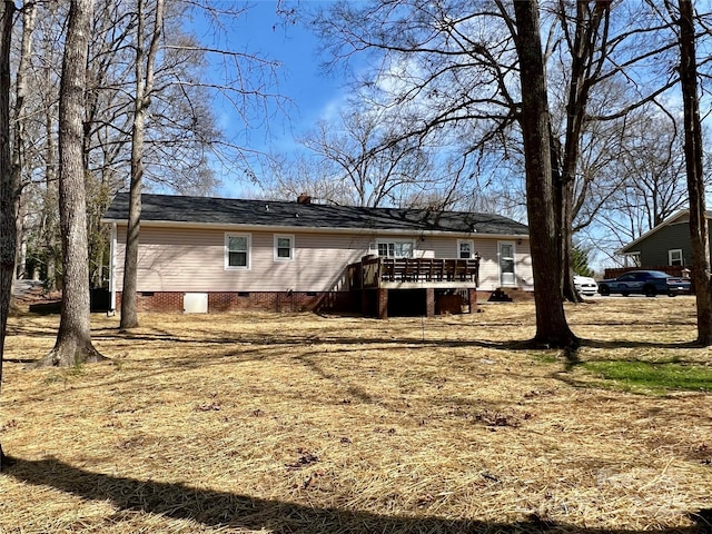 rear view of house with crawl space and a deck