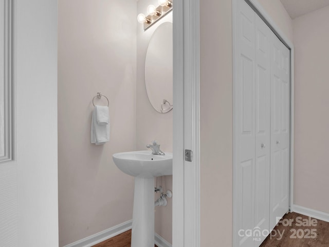 bathroom featuring a closet and baseboards