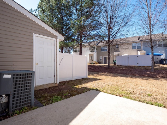 view of yard featuring a patio area, cooling unit, and fence