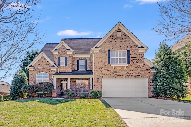 traditional-style house featuring a front yard, concrete driveway, brick siding, and an attached garage