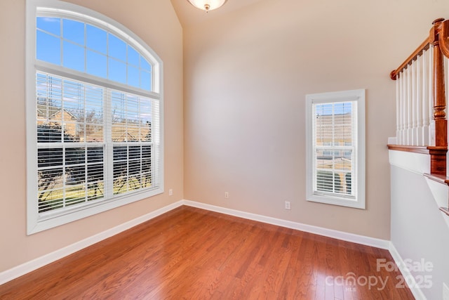 unfurnished room featuring baseboards and wood finished floors