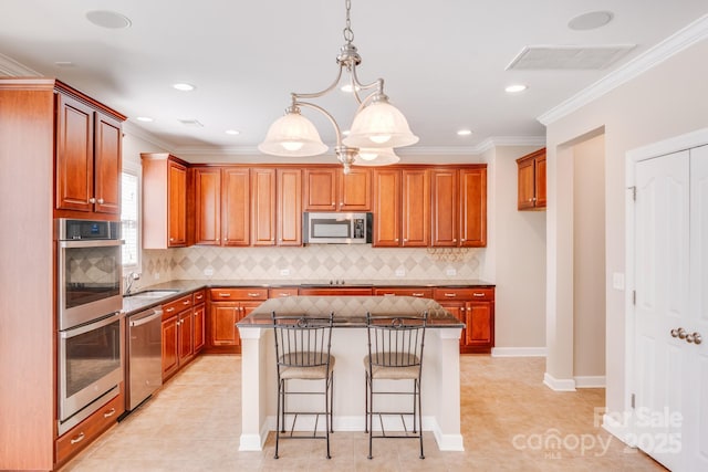 kitchen featuring stainless steel appliances, a kitchen island, visible vents, a kitchen breakfast bar, and dark stone countertops