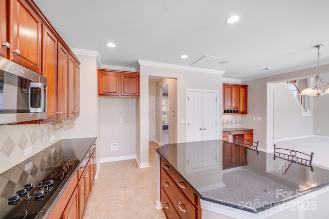 kitchen featuring a center island, crown molding, stainless steel microwave, an inviting chandelier, and black electric cooktop