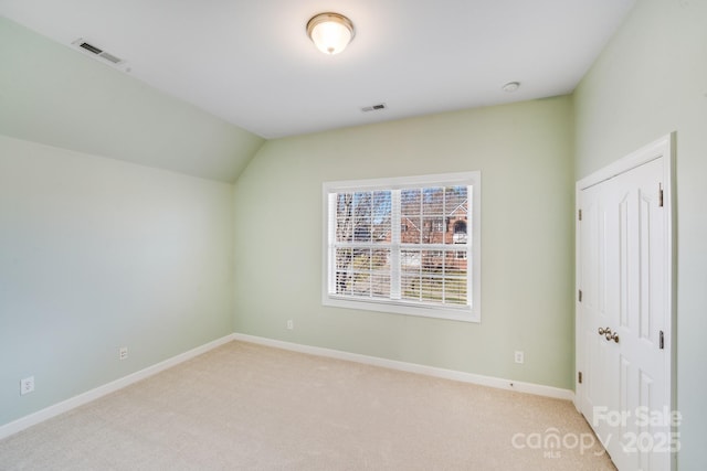 unfurnished bedroom with light carpet, baseboards, visible vents, and a closet