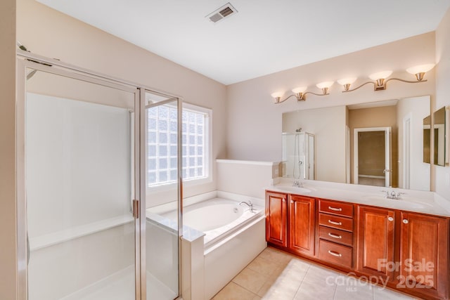 full bathroom featuring visible vents, a sink, a shower stall, a bath, and tile patterned floors