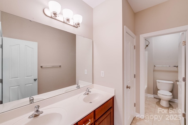 bathroom featuring toilet, tile patterned flooring, double vanity, and a sink