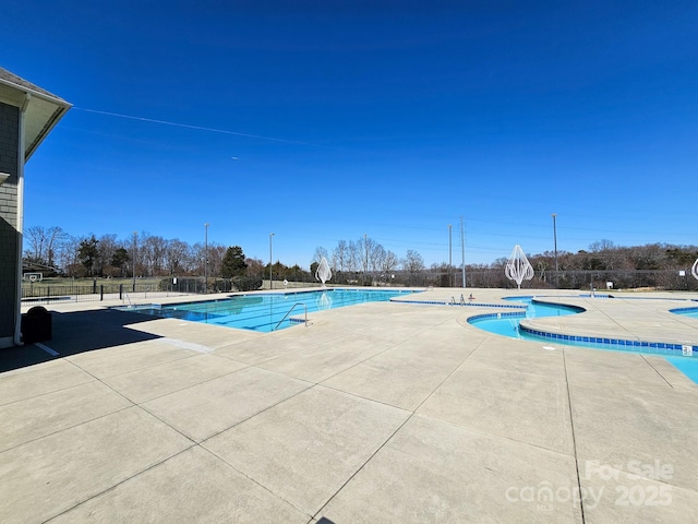 pool featuring a patio and fence