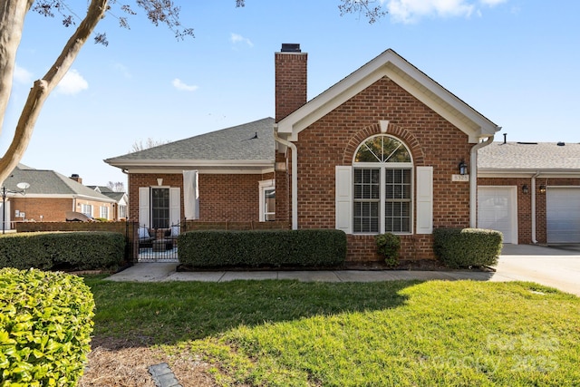 view of front of house featuring a garage, a front yard, a chimney, and brick siding