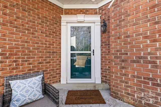 property entrance featuring brick siding