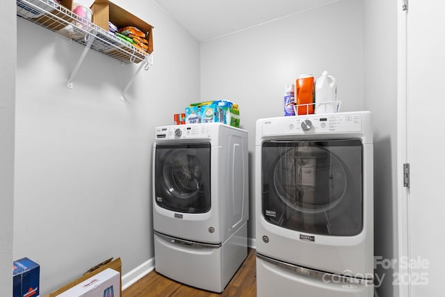 washroom featuring laundry area, separate washer and dryer, and wood finished floors