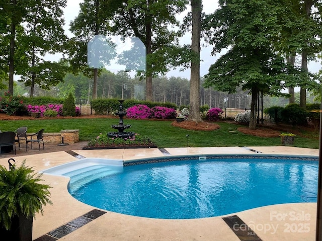 view of swimming pool with a fenced in pool, a patio area, fence, and a lawn