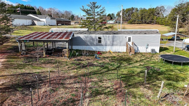 view of yard featuring entry steps and a trampoline