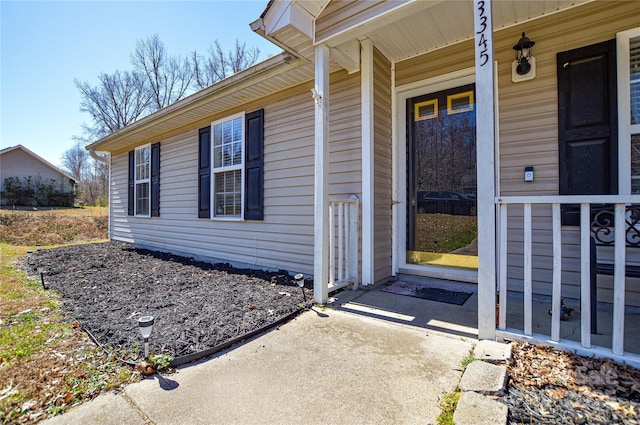 view of exterior entry featuring covered porch