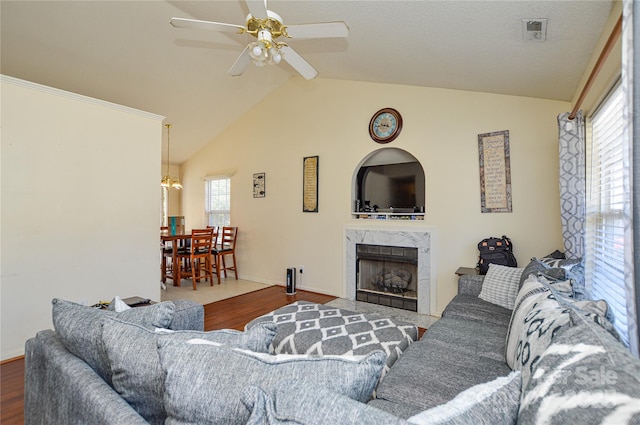 living room featuring wood finished floors, visible vents, and a wealth of natural light