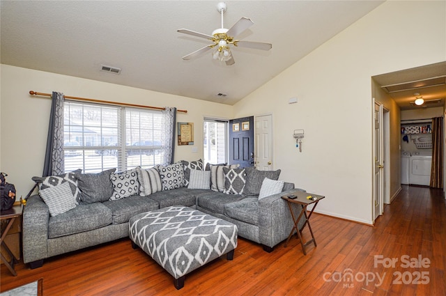 living area featuring a ceiling fan, wood finished floors, visible vents, high vaulted ceiling, and washer and clothes dryer