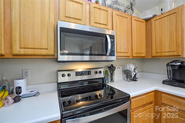 kitchen featuring stainless steel appliances and light countertops