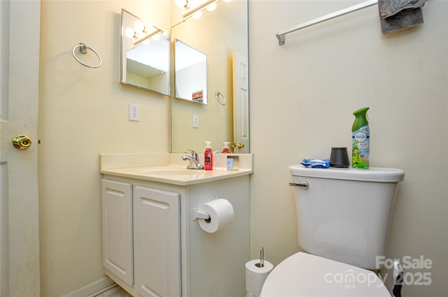 bathroom featuring toilet and vanity