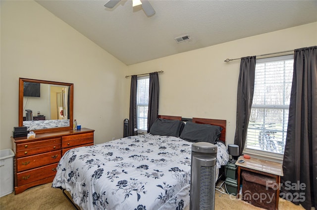 bedroom featuring carpet flooring, a textured ceiling, visible vents, and vaulted ceiling