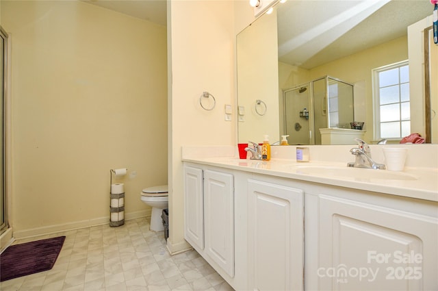 full bath with vanity, toilet, baseboards, and a stall shower