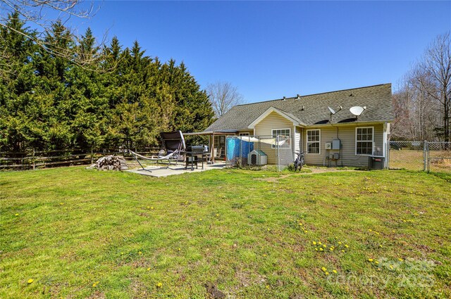 view of yard with a gate, cooling unit, a patio, and fence