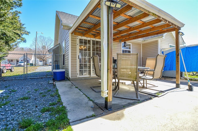 view of patio / terrace with a gate, outdoor dining space, and fence