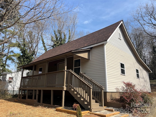 exterior space featuring a shingled roof