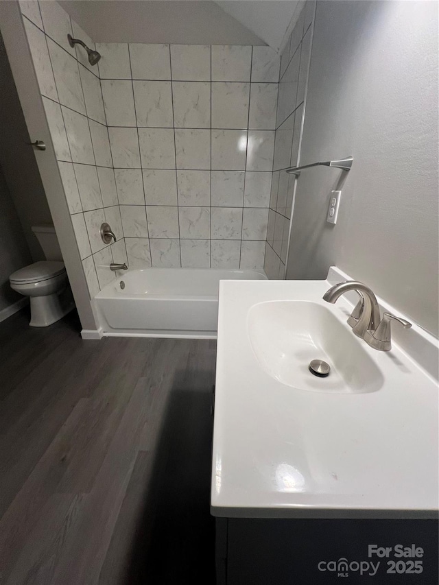 full bathroom featuring shower / bathtub combination, vanity, toilet, and wood finished floors