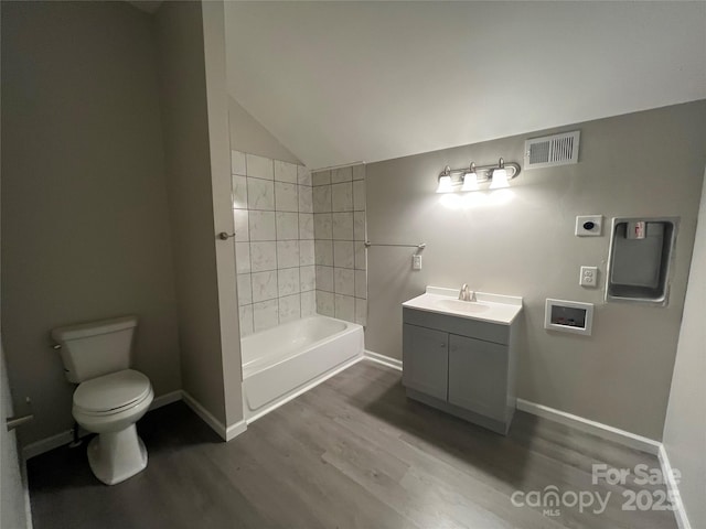 full bath with baseboards, visible vents, toilet, wood finished floors, and vanity