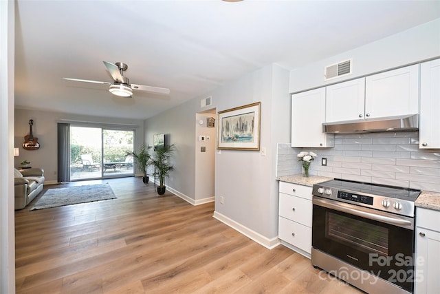 kitchen featuring stainless steel electric stove, visible vents, backsplash, white cabinets, and under cabinet range hood