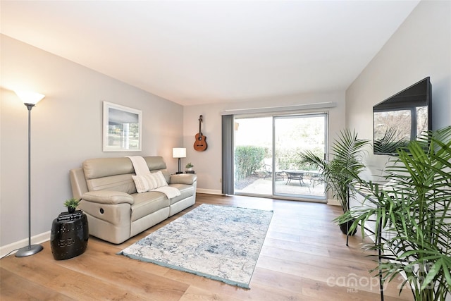 living room featuring baseboards and wood finished floors