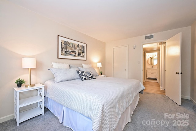 bedroom featuring light carpet, baseboards, and visible vents