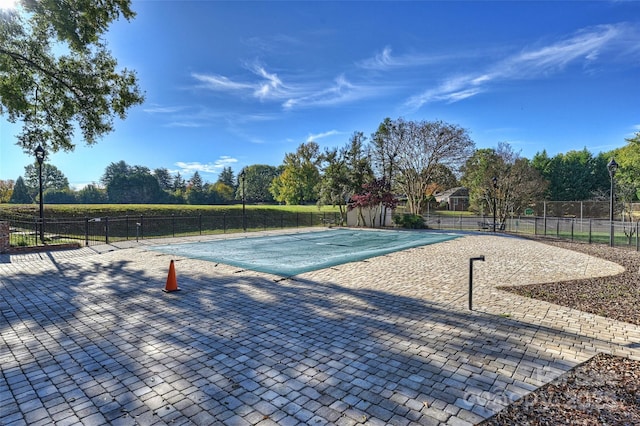 view of swimming pool featuring a fenced in pool, a patio area, and fence