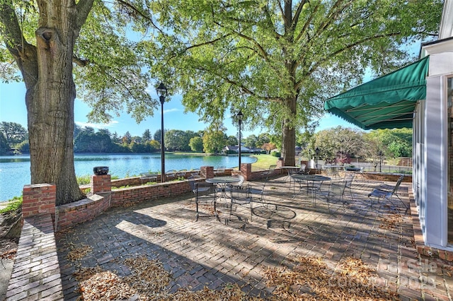 view of patio with a water view