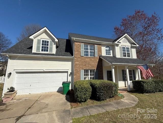 view of front of property with brick siding, driveway, and an attached garage