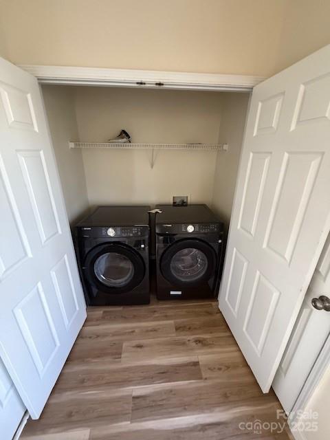 laundry area featuring laundry area, light wood-style floors, and washer and dryer