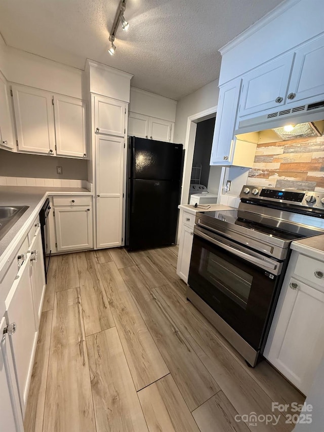 kitchen featuring light wood-style flooring, under cabinet range hood, white cabinets, electric stove, and freestanding refrigerator