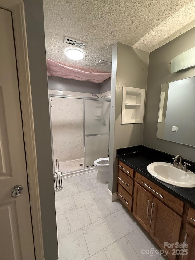 bathroom with marble finish floor, visible vents, toilet, a shower stall, and vanity