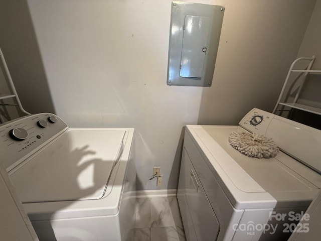 washroom with laundry area, electric panel, baseboards, washing machine and clothes dryer, and marble finish floor