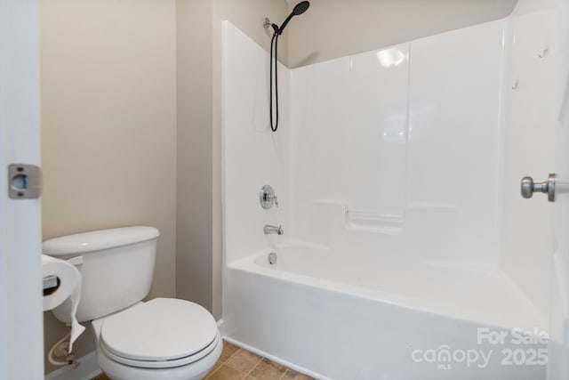 full bathroom with baseboards, tub / shower combination, and toilet