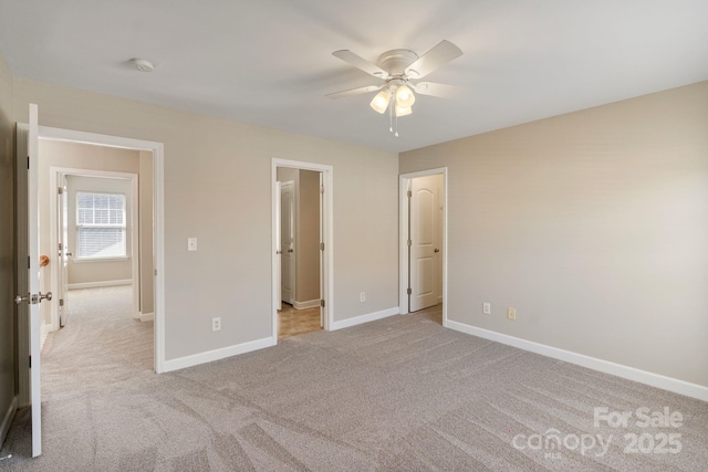 unfurnished bedroom with carpet floors, baseboards, and a ceiling fan