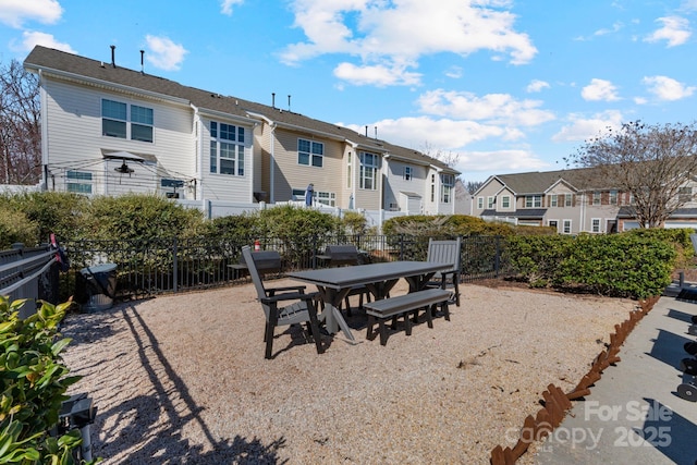 view of patio / terrace with a residential view, fence, and outdoor dining area