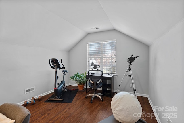 office space featuring lofted ceiling, wood finished floors, visible vents, and baseboards