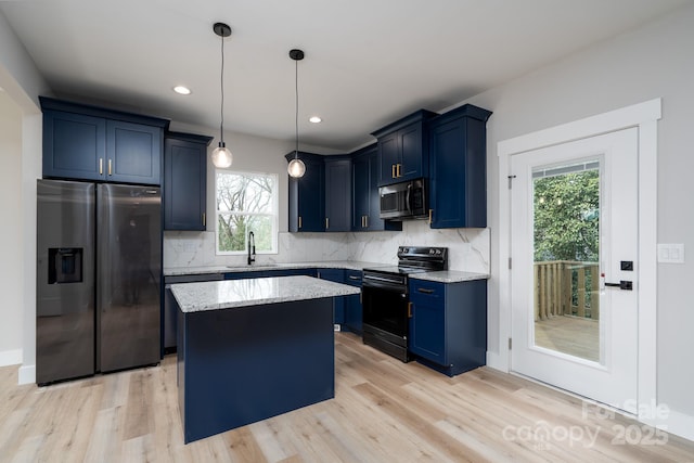 kitchen with light stone counters, blue cabinets, a sink, appliances with stainless steel finishes, and tasteful backsplash