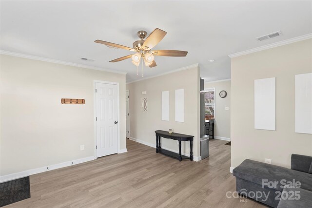 living area with visible vents, baseboards, and light wood-style floors