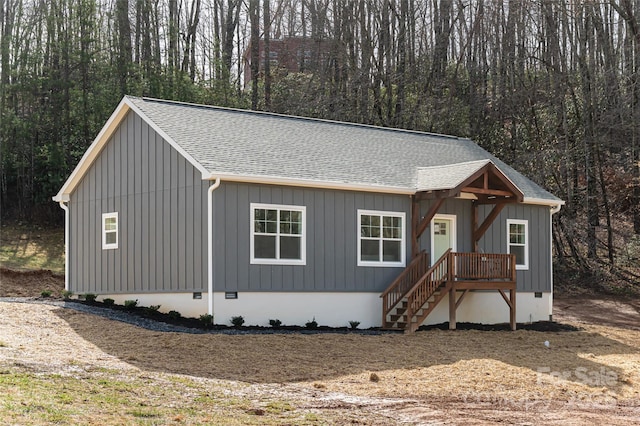 view of front of house featuring a shingled roof, crawl space, and board and batten siding