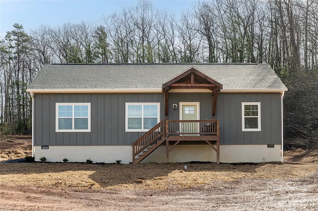 manufactured / mobile home featuring roof with shingles and crawl space